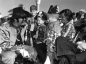 Two costumed boys being entertained at the Gasparilla parade - Tampa, Florida.