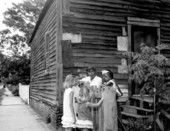 Three children talking with an African American family at the Julee Cottage - Pensacola, Florida.