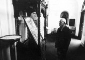 Old man examining painting of a weeping icon at St. Nicholas Orthodox Church