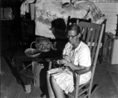 Woman weaving a basket in Adam's country store - White Springs, Florida
