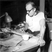 Artist Dick Gaige painting pelicans on driftwood