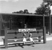 Woman sitting in pillory at the oldest jail - Saint Augustine, Florida