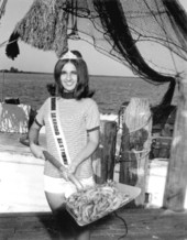 Miss Florida Seafood holding a shovelful of shrimp at the seafood festival