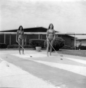 Two young women play shuffleboard - Fort Walton Beach, Florida