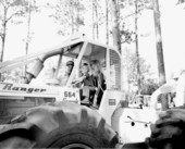 Young child at the wheel of a tractor at the Florida Forest Festival.