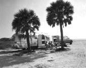 Couple sitting by a trailer on the beach - Gasparilla Island, Florida