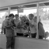 Tourists watch as trainer holds baby lion cub at the Lion Country Safari zoo