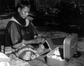 Seminole woman beadworking at the Okalee Indian Village and Crafts Center.