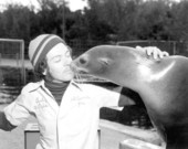 Animal trainer from the Theater of the Sea receives a sea lion "kiss" - Islamorada, Florida