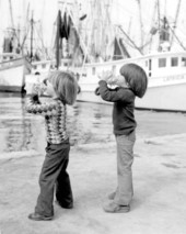 Two young boys blowing into a seashells at the Old Island Days Festival in Key West.