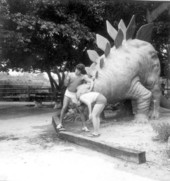 Tourists posed with Stegosaurus dinosaur statue at the Lion Country Safari zoo.