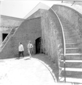 Two women passing by the brick stairs within Fort Pickens - Santa Rosa Island, Florida.