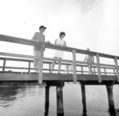 Two ladies fishing on the pier at Saint Andrews State Park - Panama City, Florida.