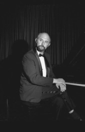 Portrait of concert pianist Yehuda Guttman seated at the Red Barn Theatre piano - Key West, Florida.
