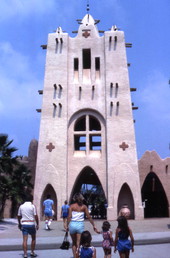 View showing visitors walking toward a building at the Busch Gardens amusement park - Tampa, Florida.