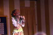 Woman singing while holding a snake during performance at the Busch Gardens amusement park in Tampa, Florida.