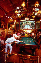 Tourists shooting pool at the Cheyenne Saloon and Opera House in Church Street Station - Orlando, Florida.
