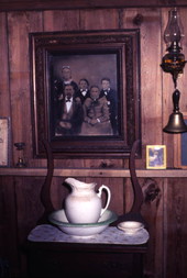 Interior view of an old house showing wash basin and family portrait at the Crowley Museum and Nature Center - Sarasota, Florida.