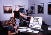 Women viewing poster for a Florida Trade Exhibit.