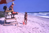 Girl talking with lifeguard at the Canaveral National Seashore beach in Brevard County near Titusville, Florida.