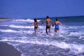 People running in the surf at the Canaveral National Seashore beach in Brevard County near Titusville, Florida.