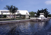 Boat docked next to a waterfront home in Cocoa, Florida.