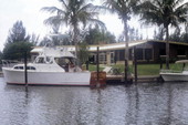 Boat docked by a waterfront home in Cocoa, Florida.