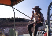 Tour guide speaking aboard a tour vehicle in the Everglades.