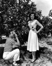 Ed Carter takes picture for Marion Ettie posing in an orange grove - Polk County, Florida