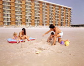 Family making a sandcastle on the beach - Jacksonville, Florida