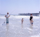 Family fishing at the beach by the pier - Jacksonville Beach, Florida