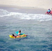 Young women on inflatable rafts enjoying the water - Lake Worth, Florida