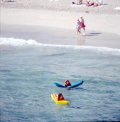 Young women on inflatable rafts enjoying the water - Lake Worth, Florida