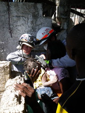 View showing MDFR FL-TF1 helping to save a 2-year-old child during the 2010 Haiti Earthquake rescue efforts.