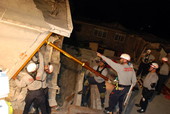 View showing MDFR FL-TF1 personnel shoring up a wall during search and rescue efforts following the 2010 Haiti Earthquake.