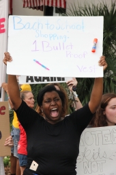 Student demonstrator with her sign at the Old Capitol during the Never Again Rally in Tallahassee.