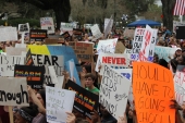 Close-up view showing student demonstrators with their signs at the Never Again Rally in Tallahassee.