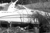 Man inspects boat washed ashore by Hurricane Ivan - Navarre, Florida.