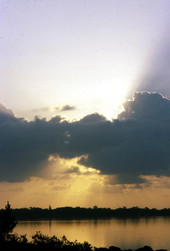 View of sunrise behind clouds at Cedar Key - Levy County, Florida