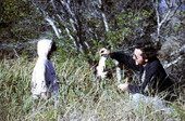 Three year old Marcy LaHart looking at bird with Bob Cane
