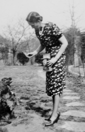 Alice T. Joyner feeding Spot a Milk-Bone biscuit treat.