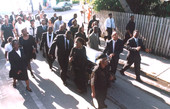 Casket of Mr. Albert Kee being moved down Angela Street during funeral procession - Key West, Florida.