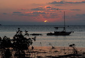 Sun rising over a sailboat off South Roosevelt Boulevard - Key West, Florida