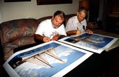 Artist George Carey and Captain Dick Steadman co-signing prints from a painting - Key West, Florida.
