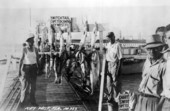 Men standing on dock by their catch of fish - Key West, Florida.
