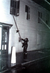 Members of the KWFD combating fire at "Swifts Camera Shop" on the corner of Duval and Southard streets - Key West, Florida.