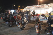 Row of motorcycles waiting for airbrush pinstriping on Main Street during Bike Week 2006 - Daytona Beach, Florida.