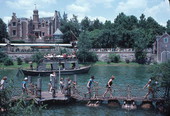 Visitors crossing barrel bridge to Tom Sawyer Island attraction at the Magic Kingdom - Orlando, Florida.