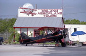 View showing a Waco bi-plane parked in front of the Island Aeroplane Tours business at the Key West International Airport.