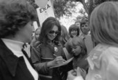 Marlo Thomas, actress autographs a notebook for a young fan at an ERA rally - Tallahassee, Florida.